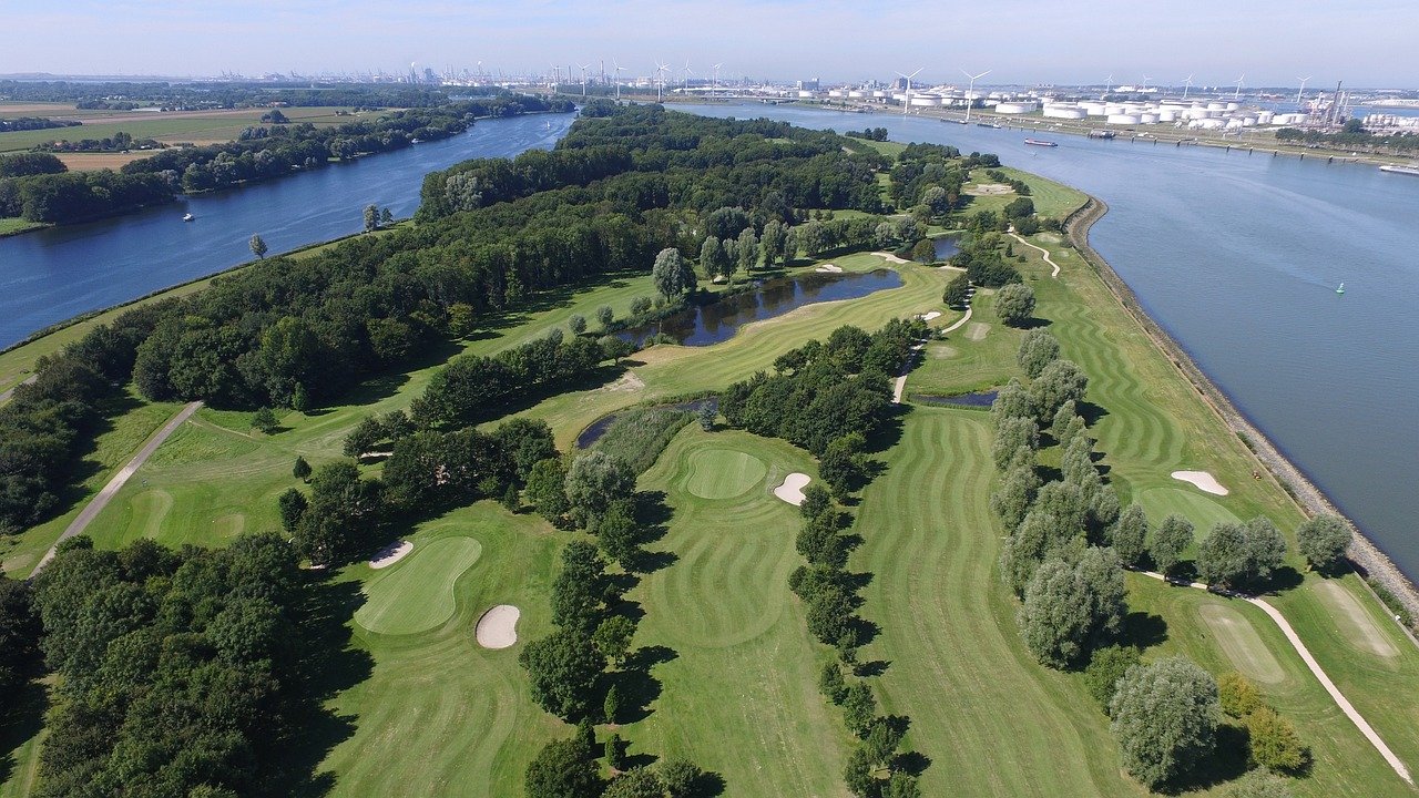 Golf course in a bird eye view where lot of trees and playground