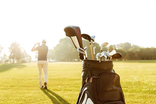 a golf bag in the golf course where a player is playing golf