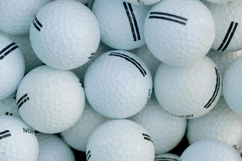 A detailed close-up shot of a pile of golf balls indicates golf balls weigh